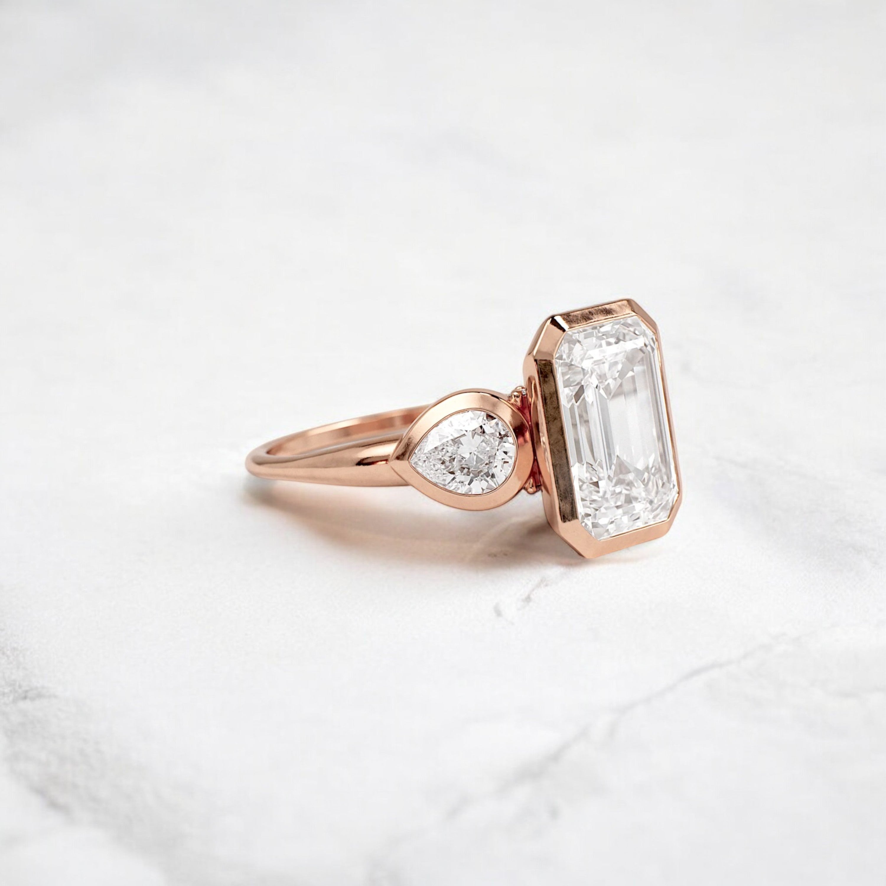 bezel-emerald-moissanite-engagement-ring-pear-side-sparkle-stones-3-ct-rose-gold-gemfora-2