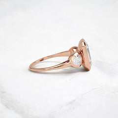 bezel-emerald-moissanite-engagement-ring-pear-side-sparkle-stones-3-ct-rose-gold-gemfora-3