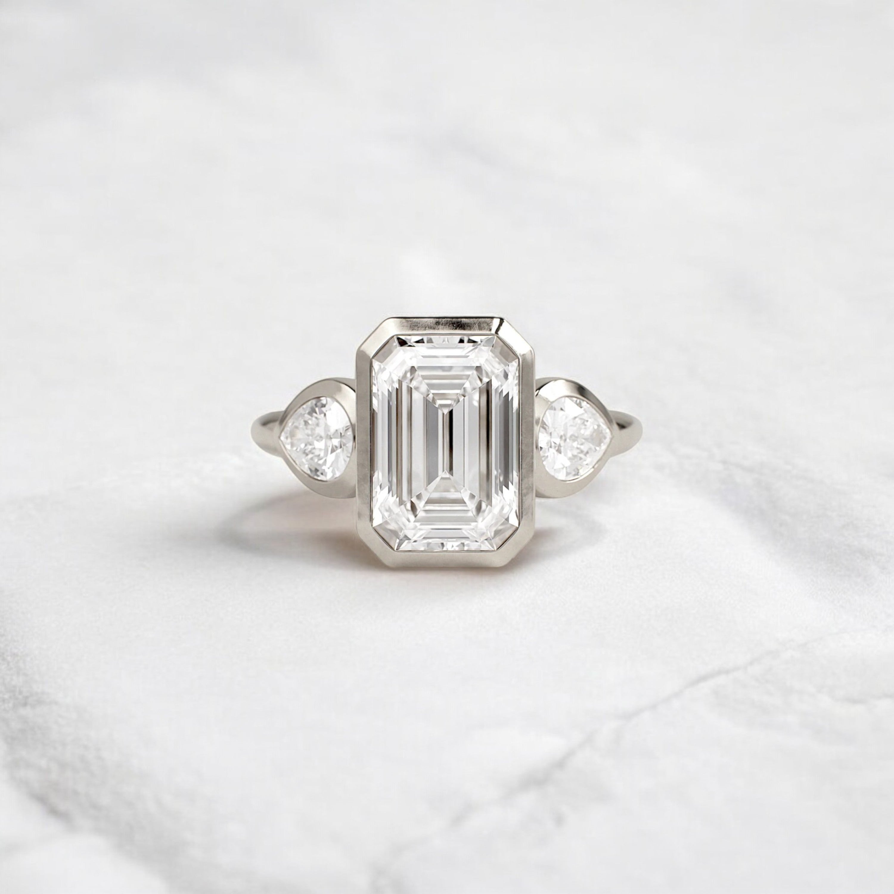 bezel-emerald-moissanite-engagement-ring-pear-side-sparkle-stones-3-ct-white-gold-gemfora-1