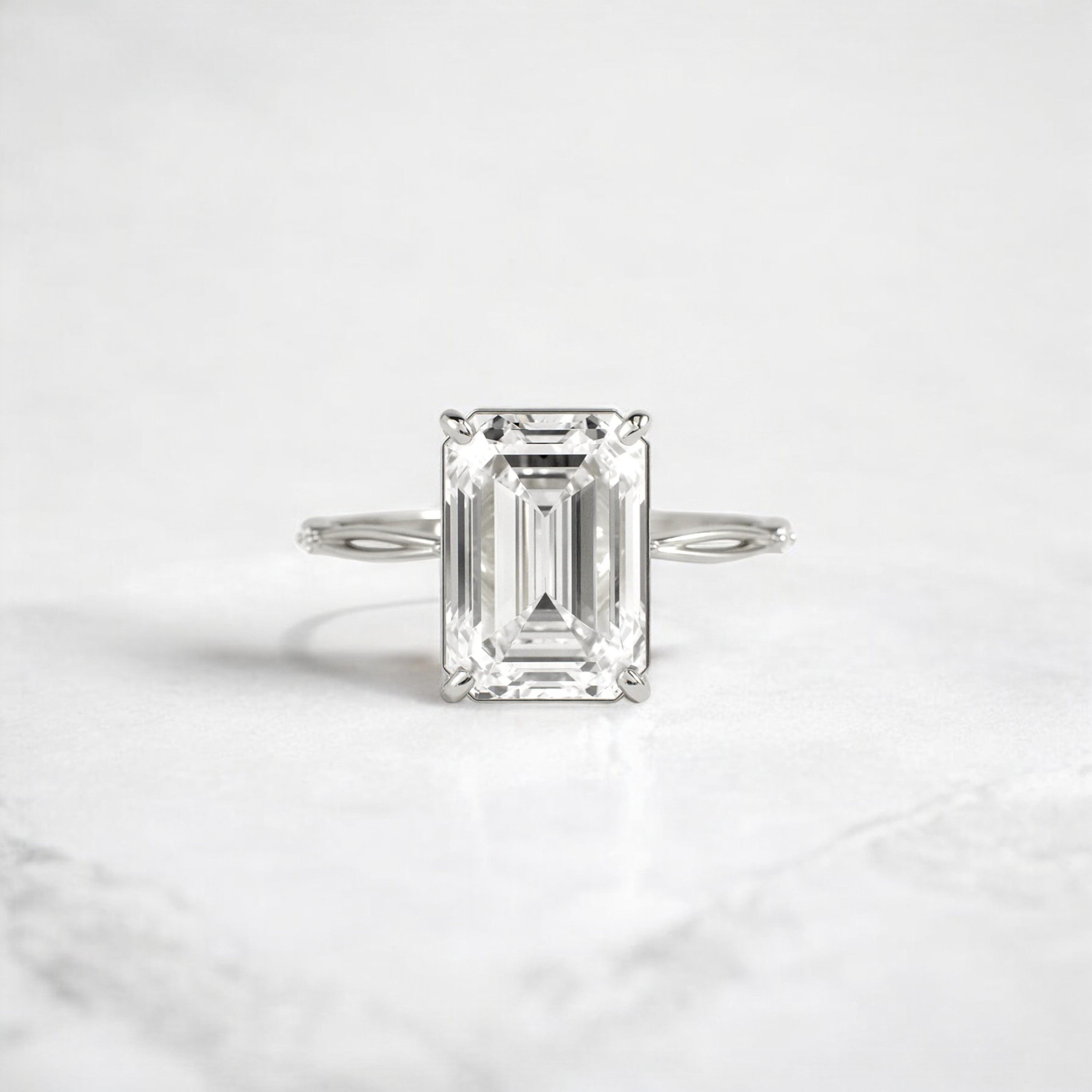 emerald-cut-engagement-ring-classic-crossed-moissanite-band-4-ct-platinum-gemfora-1