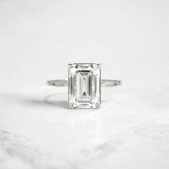 emerald-cut-engagement-ring-classic-crossed-moissanite-band-4-ct-platinum-gemfora-1