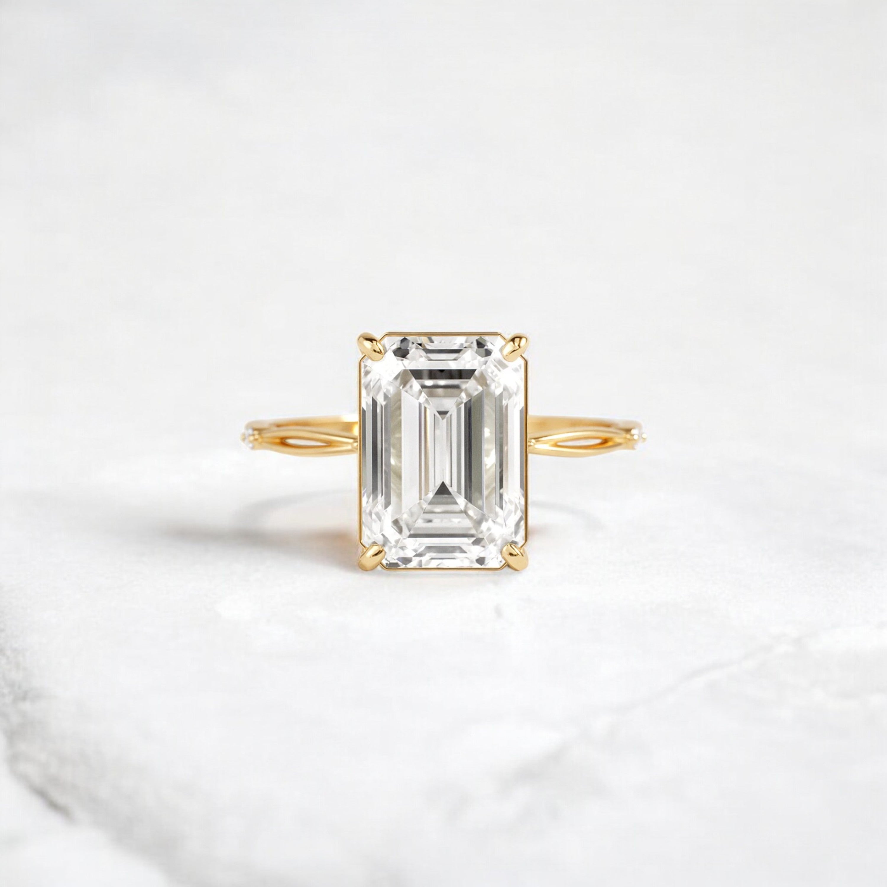 emerald-cut-engagement-ring-classic-crossed-moissanite-band-4-ct-yellow-gold-gemfora-1