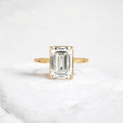 emerald-cut-engagement-ring-classic-crossed-moissanite-band-4-ct-yellow-gold-gemfora-1