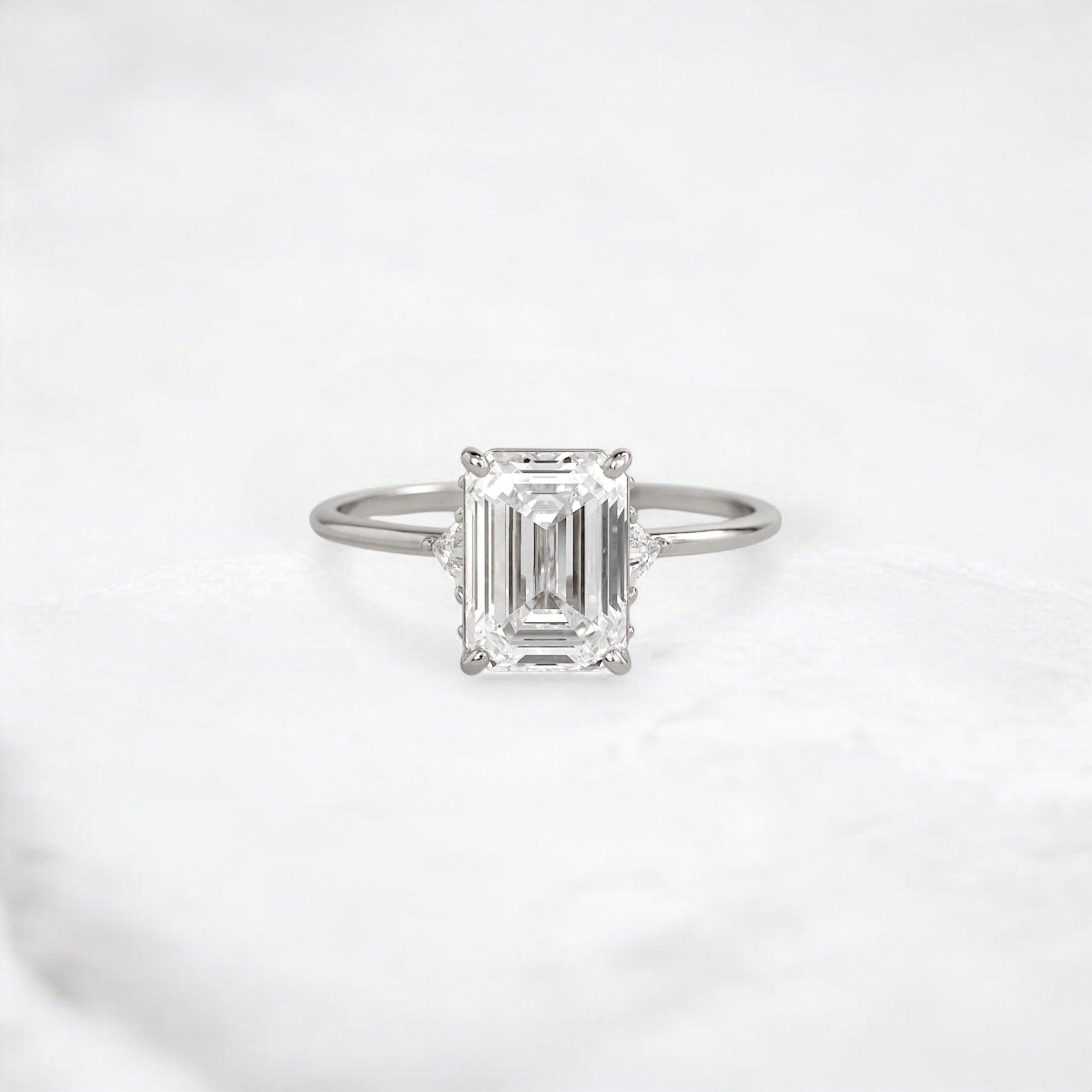 ethereal-flame-emerald-three-stone-moissanite-engagement-ring-2-ct-platinum-gemfora-1