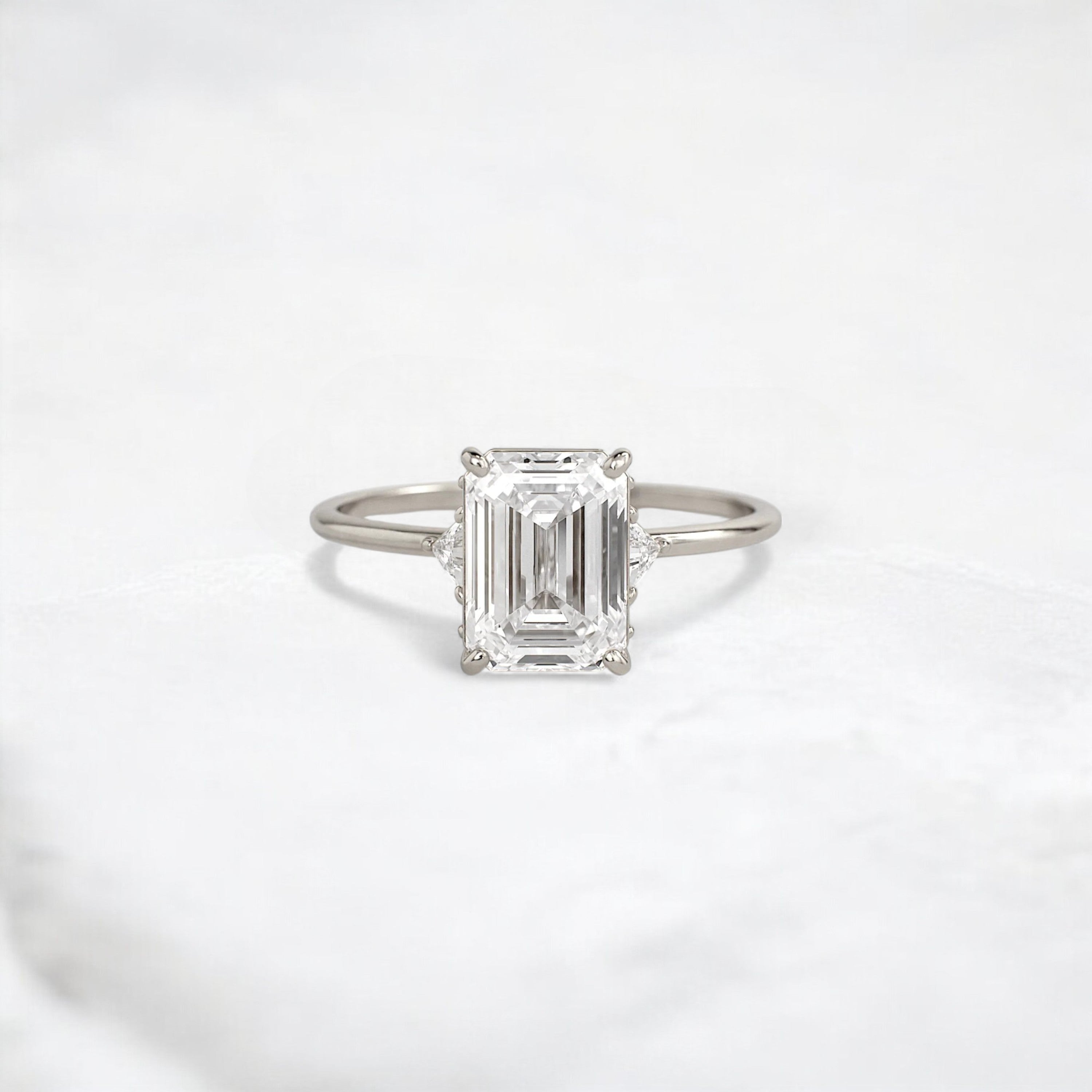 ethereal-flame-emerald-three-stone-moissanite-engagement-ring-2-ct-white-gold-gemfora-1