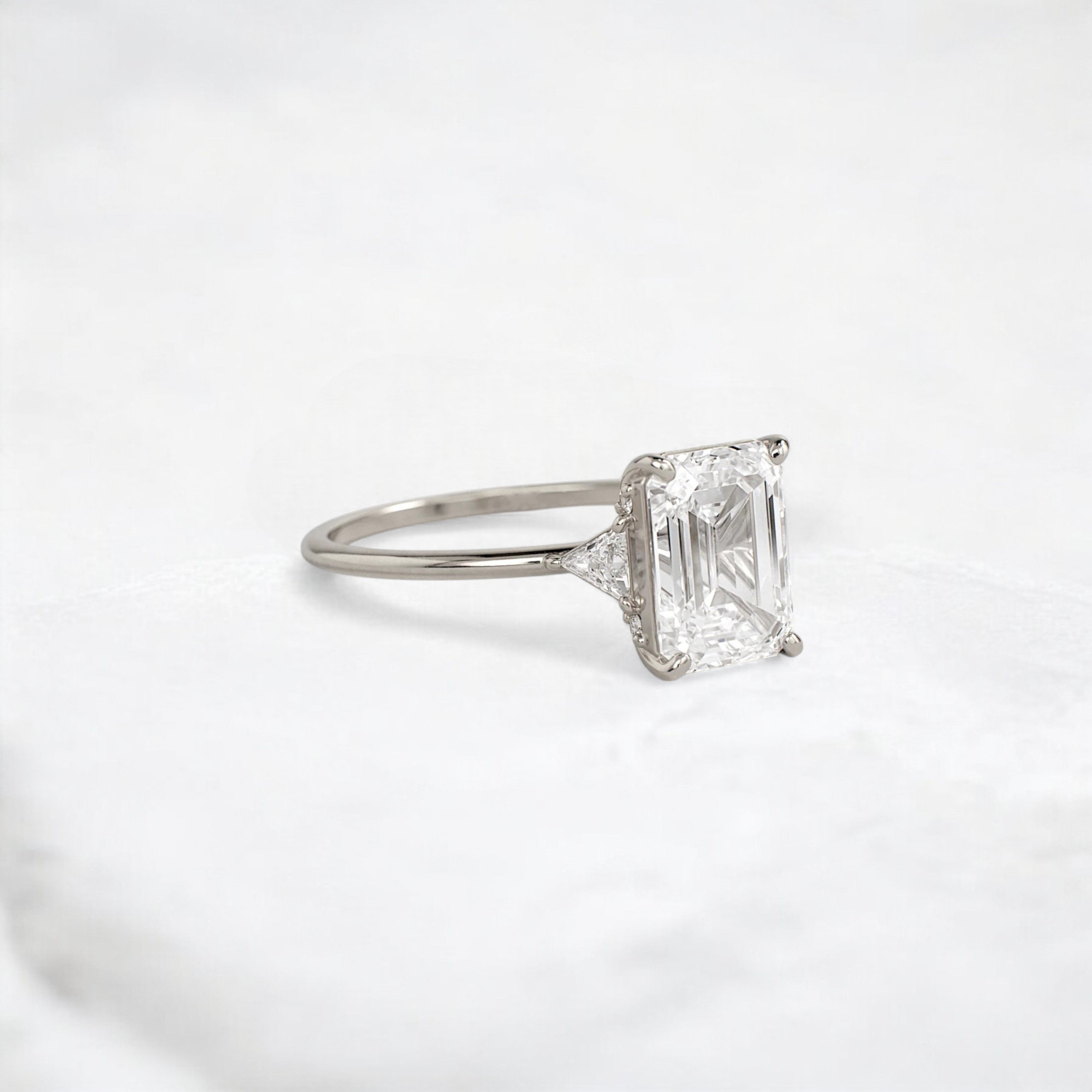 ethereal-flame-emerald-three-stone-moissanite-engagement-ring-2-ct-white-gold-gemfora-2