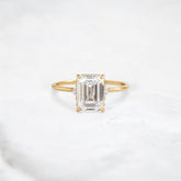 ethereal-flame-emerald-three-stone-moissanite-engagement-ring-2-ct-yellow-gold-gemfora-1