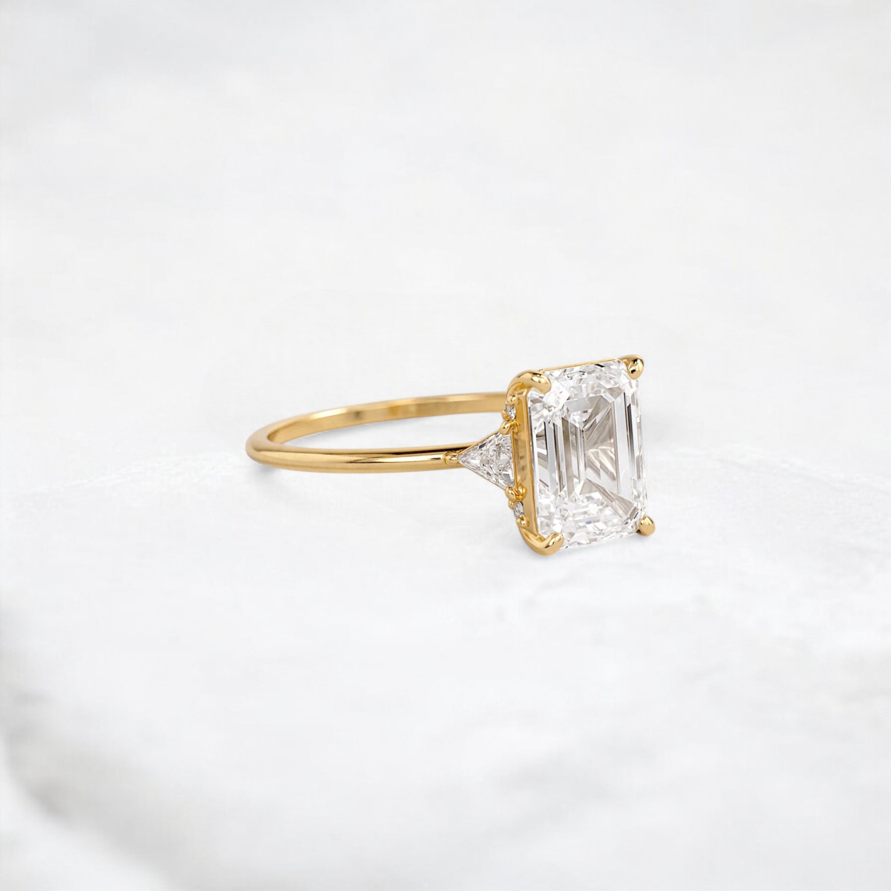 ethereal-flame-emerald-three-stone-moissanite-engagement-ring-2-ct-yellow-gold-gemfora-2