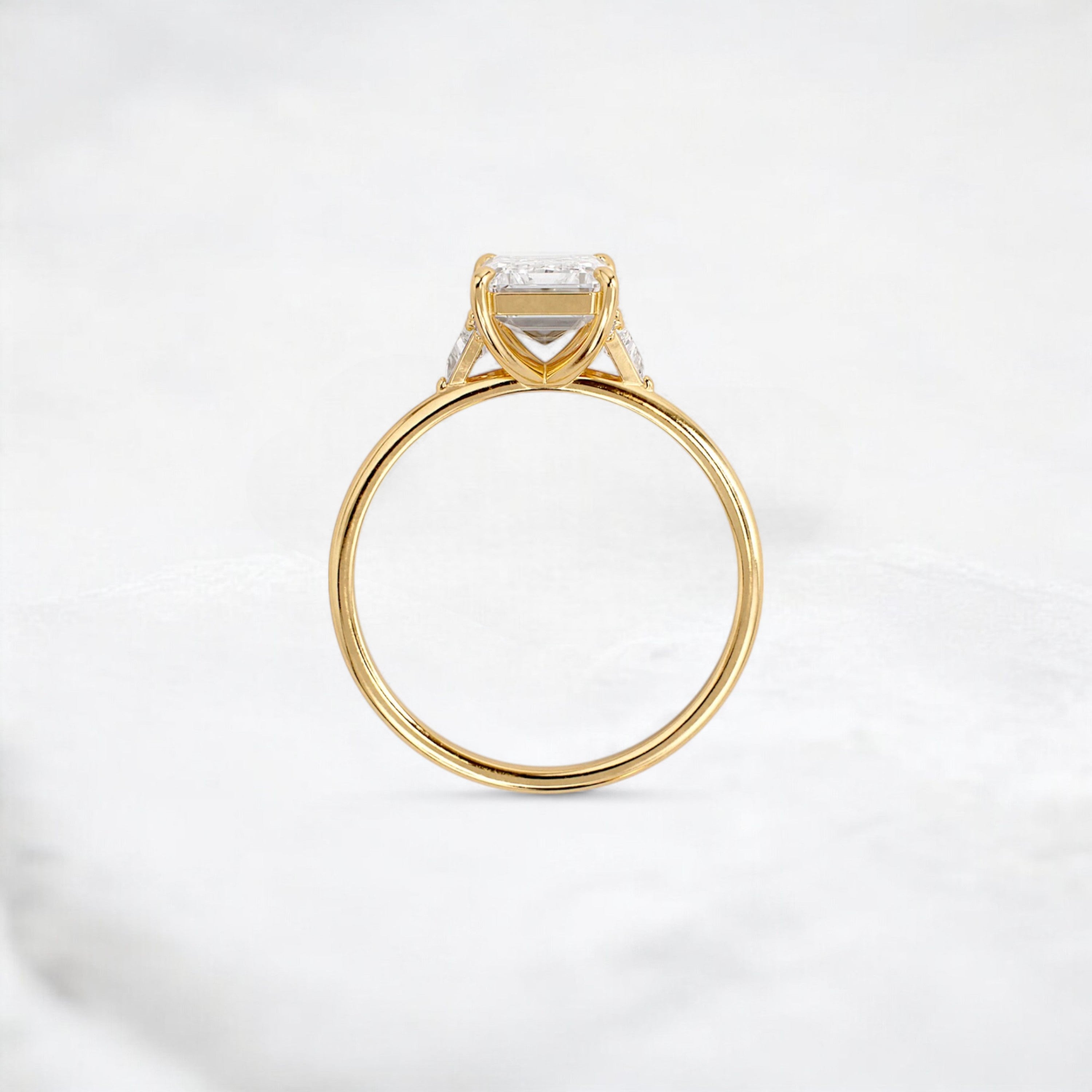 ethereal-flame-emerald-three-stone-moissanite-engagement-ring-2-ct-yellow-gold-gemfora-4