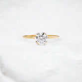 golden-dawn-round-cut-heartbeat-moissanite-engagement-ring-1-ct-yellow-gold-gemfora-1