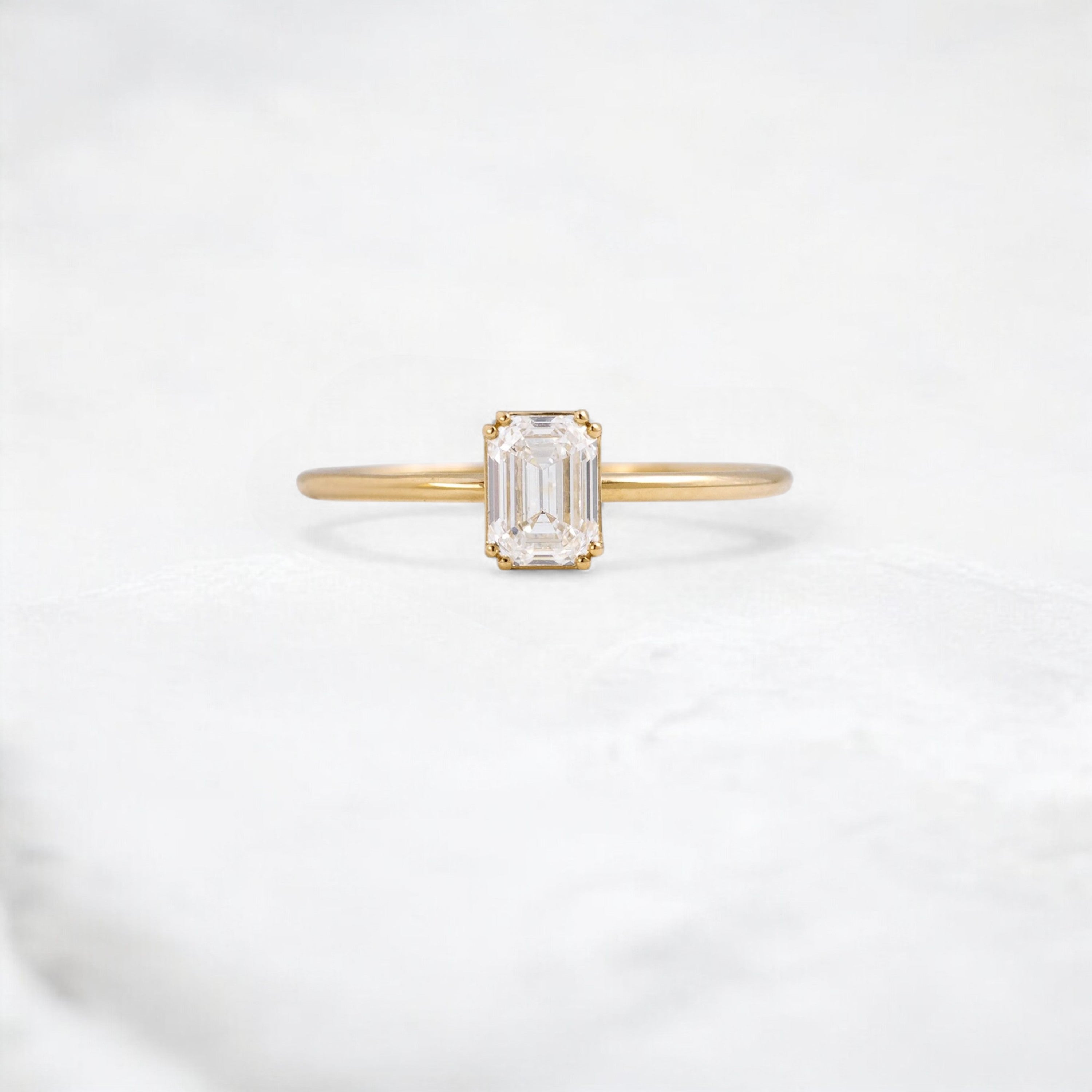 golden-lumen-emerald-solitaire-moissanite-engagement-ring-0-70-ct-yellow-gold-gemfora-1