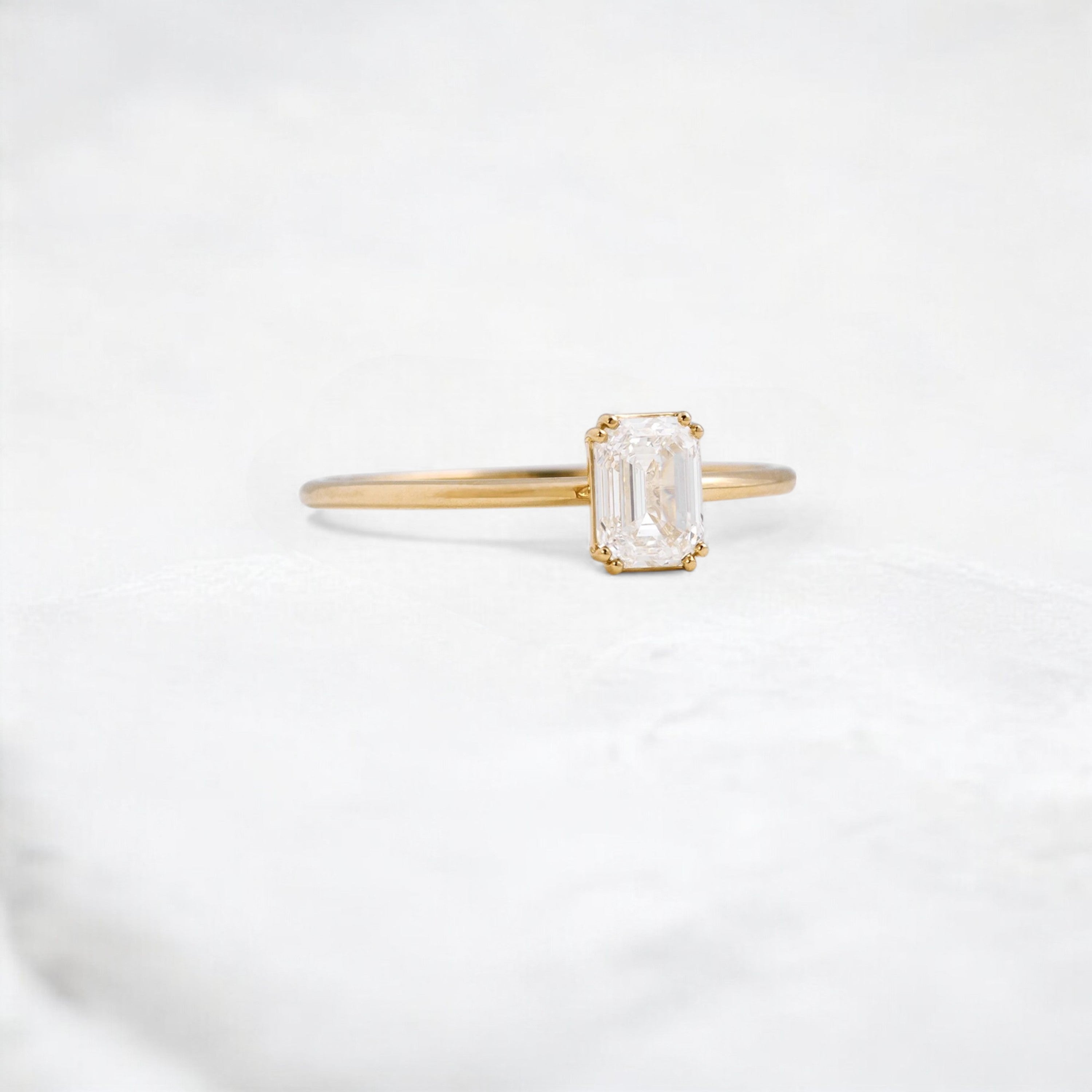golden-lumen-emerald-solitaire-moissanite-engagement-ring-0-70-ct-yellow-gold-gemfora-2
