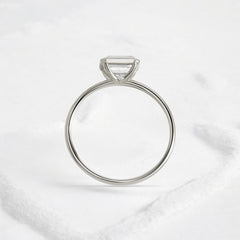 Elegant handmade emerald cut diamond engagement ring, featuring a bezel setting designed for women.