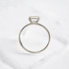 Elegant handmade emerald cut diamond engagement ring, featuring a bezel setting designed for women.