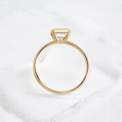 Elegant handmade emerald cut diamond engagement ring, featuring a bezel setting designed for women.