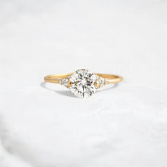 handmade-round-cut-1.14ct-moissanite-engagement-ring-with-closed-basket-and-two-tab-prongs-yellow-gold-gemfora-1