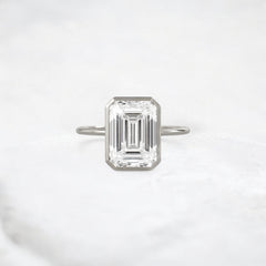 secret-glimmer-emerald-cut-bezel-moissanite-engagement-ring-4-ct-platinum-gemfora-1