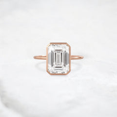 secret-glimmer-emerald-cut-bezel-moissanite-engagement-ring-4-ct-rose-gold-gemfora-1