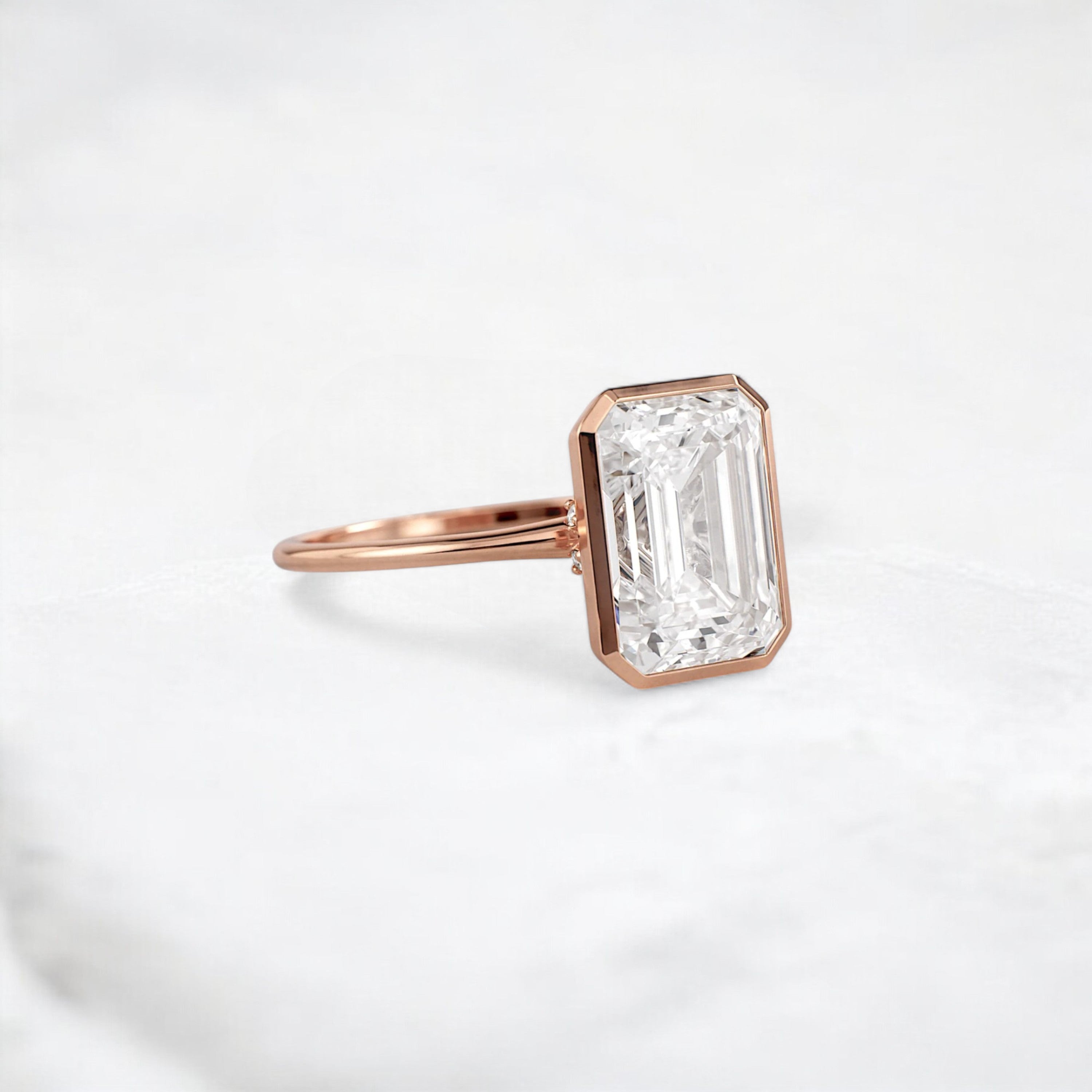 secret-glimmer-emerald-cut-bezel-moissanite-engagement-ring-4-ct-rose-gold-gemfora-2