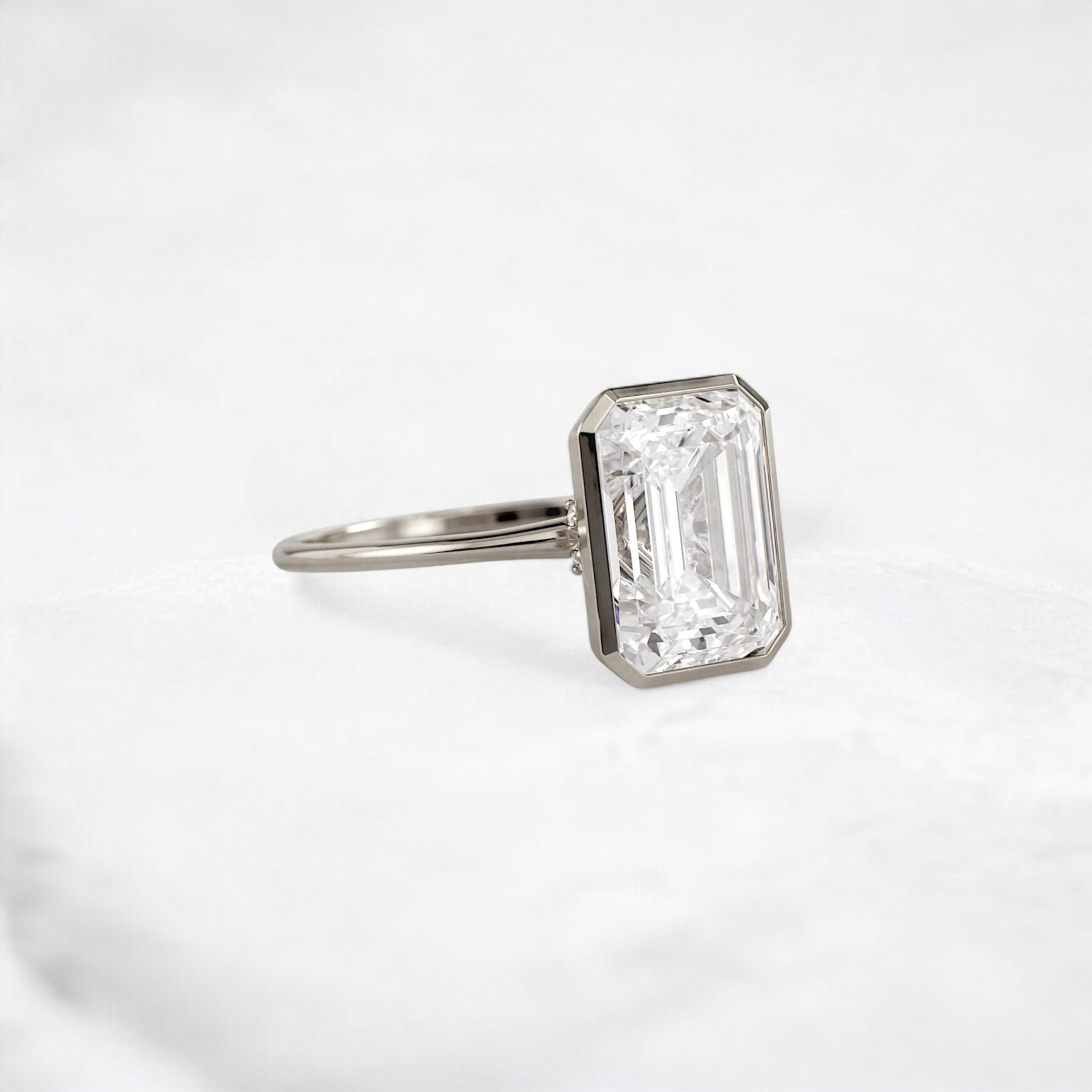 secret-glimmer-emerald-cut-bezel-moissanite-engagement-ring-4-ct-white-gold-gemfora-2