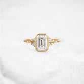 silent-luster-emerald-cluster-bezel-moissanite-engagement-ring-1-ct-yellow-gold-gemfora-1