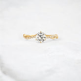 twist-of-love-round-cut-moissanite-pave-engagement-ring-0-70-ct-yellow-gold-gemfora-1