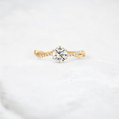 twist-of-love-round-cut-moissanite-pave-engagement-ring-0-70-ct-yellow-gold-gemfora-1
