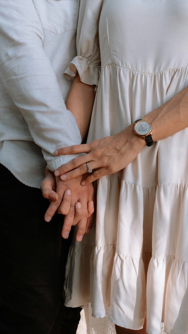 couple-holding-hand-wearing-engagement-ring