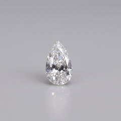 Teardrop-shaped diamond on a gray background