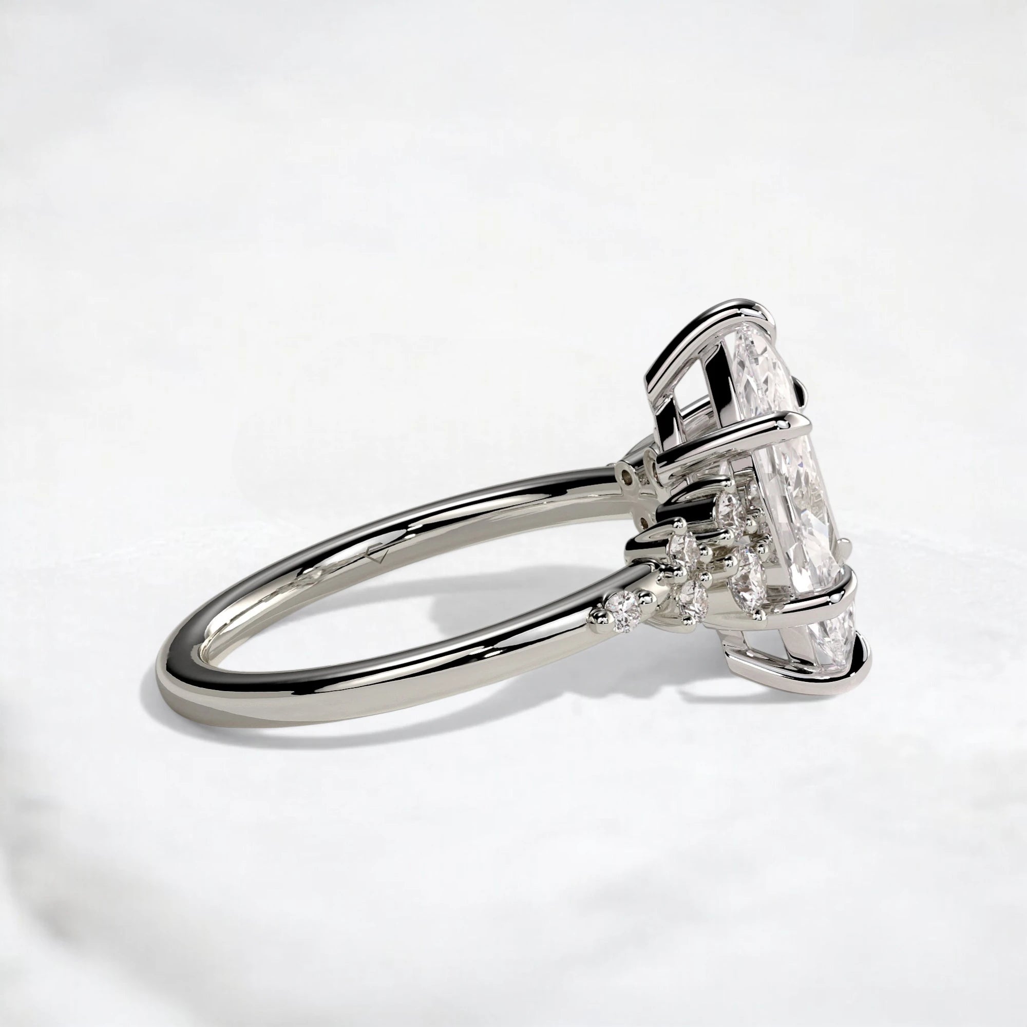 A silver-toned ring featuring a large clear rectangular gemstone in a prong setting, with smaller accent stones along the band, photographed on a clean white background.