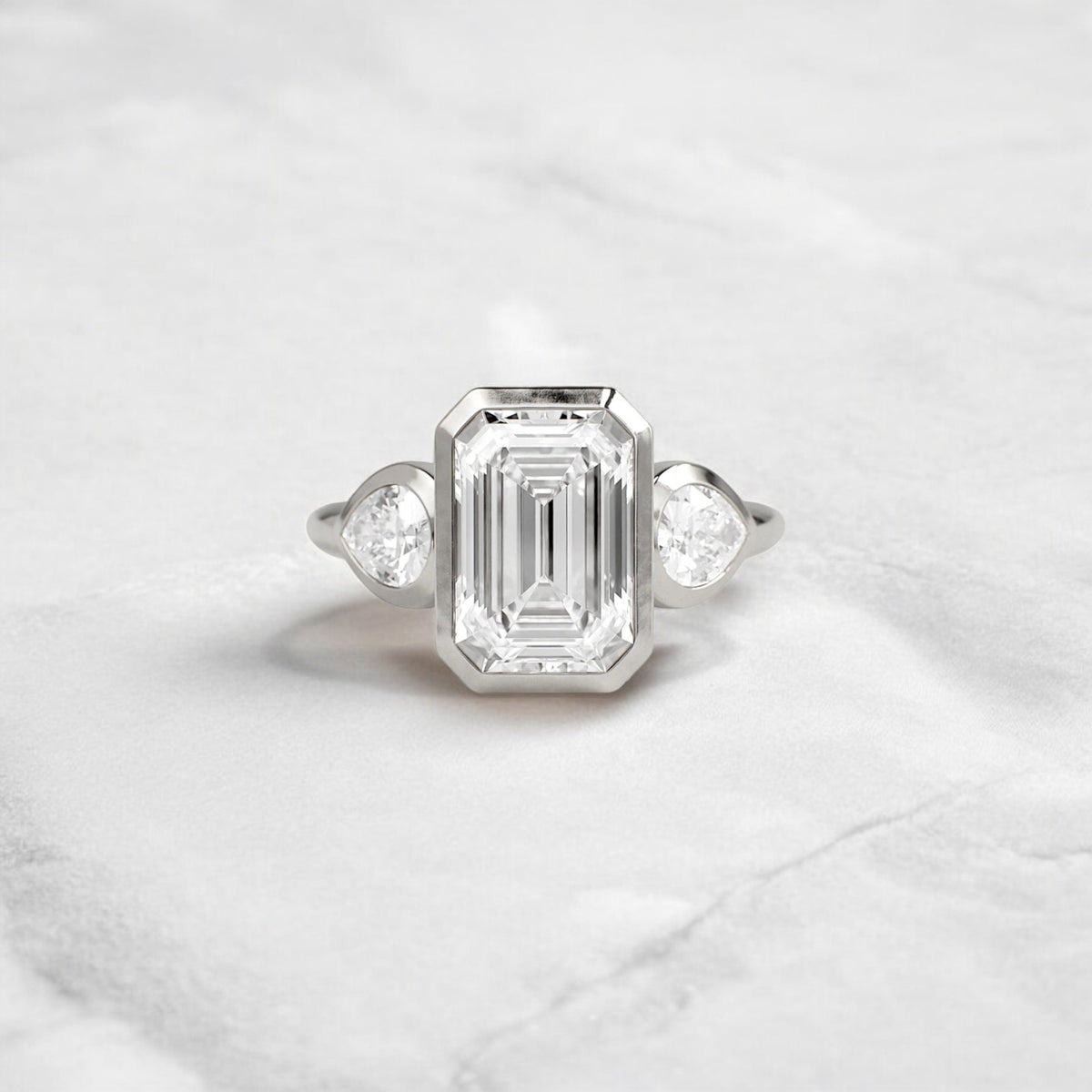 bezel-emerald-moissanite-engagement-ring-pear-side-sparkle-stones-3-ct-platinum-gemfora-1