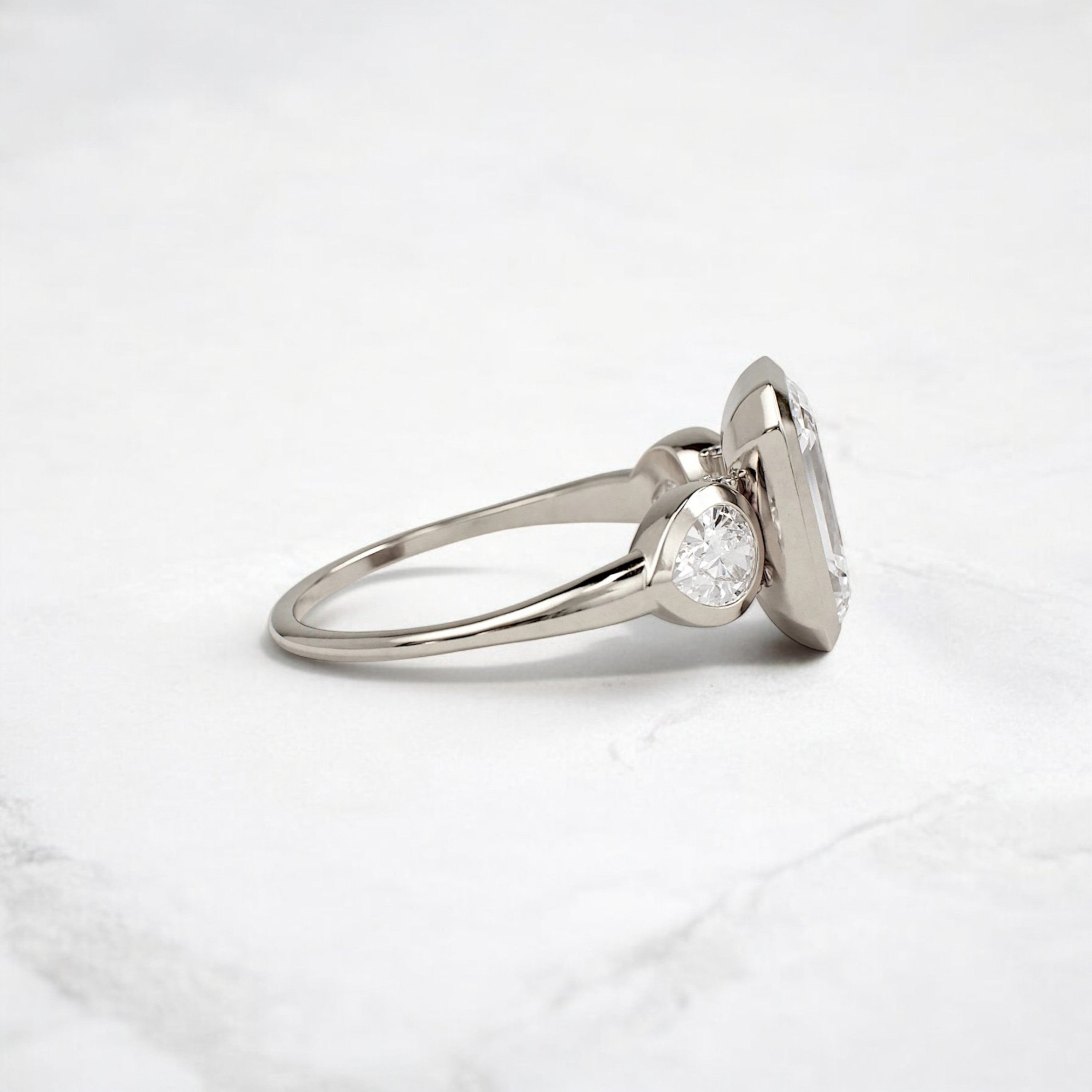 bezel-emerald-moissanite-engagement-ring-pear-side-sparkle-stones-3-ct-white-gold-gemfora-3