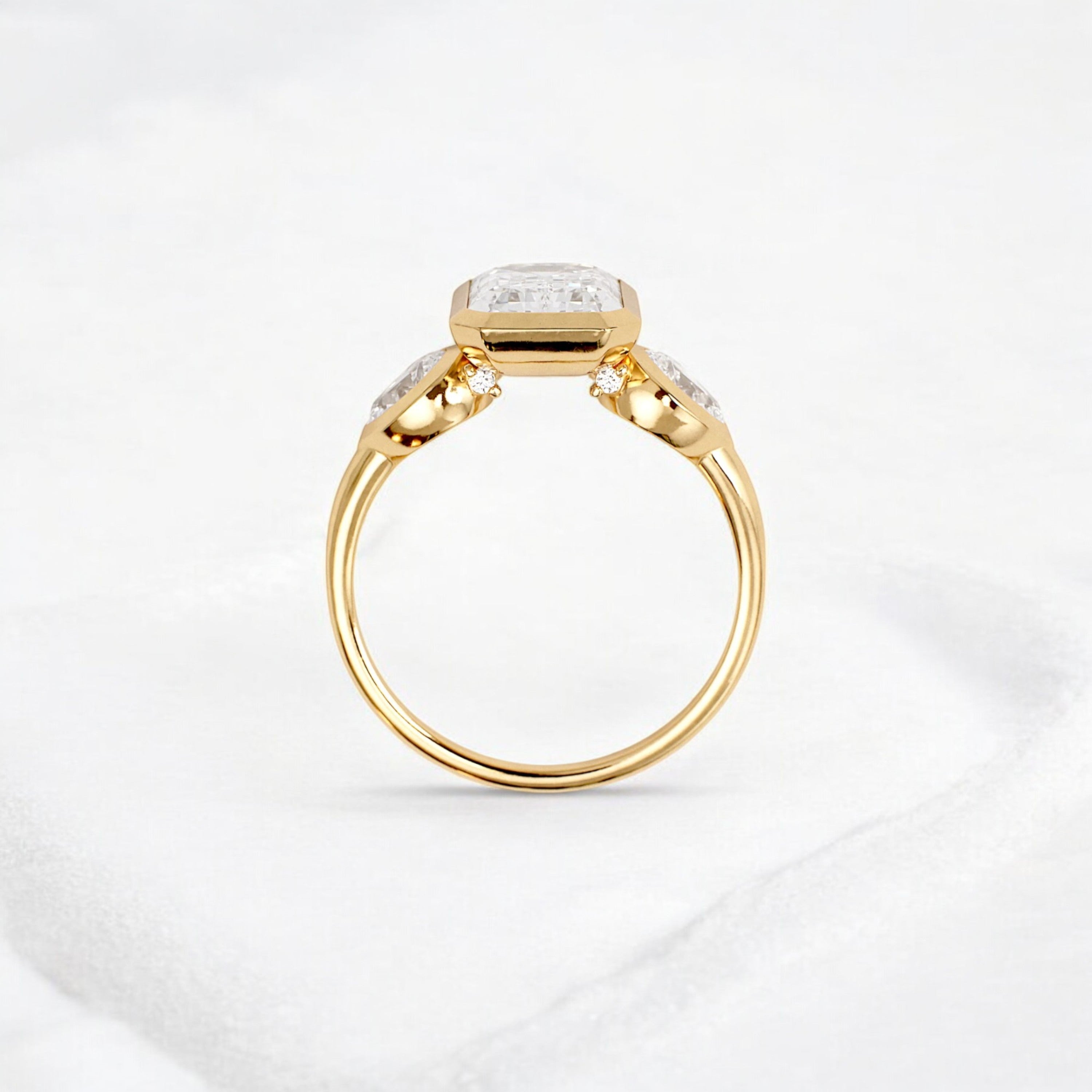 bezel-emerald-moissanite-engagement-ring-pear-side-sparkle-stones-3-ct-yellow-gold-gemfora-4
