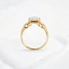 bezel-emerald-moissanite-engagement-ring-pear-side-sparkle-stones-3-ct-yellow-gold-gemfora-4