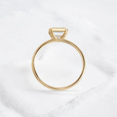Elegant handmade emerald cut diamond engagement ring, featuring a bezel setting designed for women.