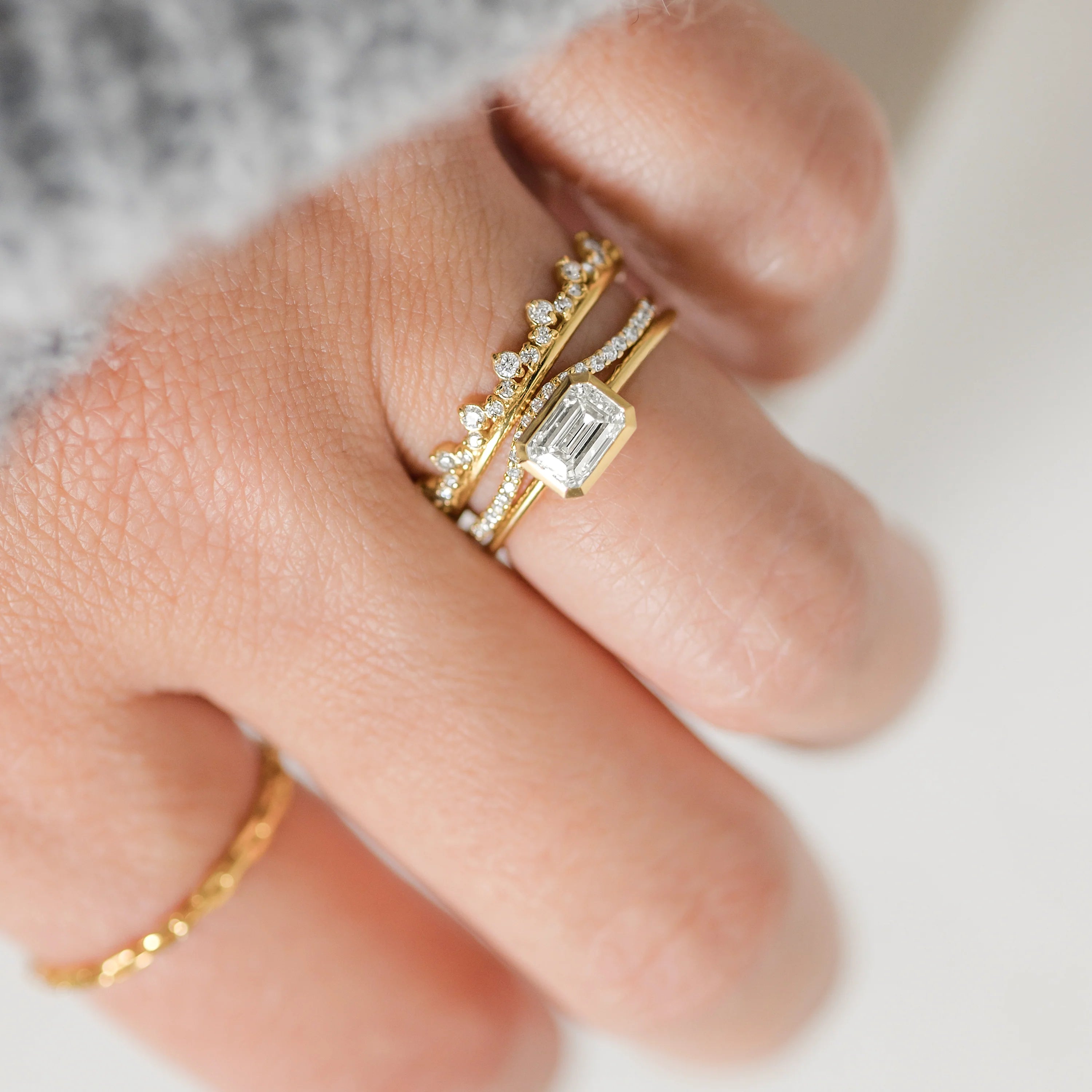 Elegant handmade emerald cut diamond engagement ring, featuring a bezel setting designed for women.