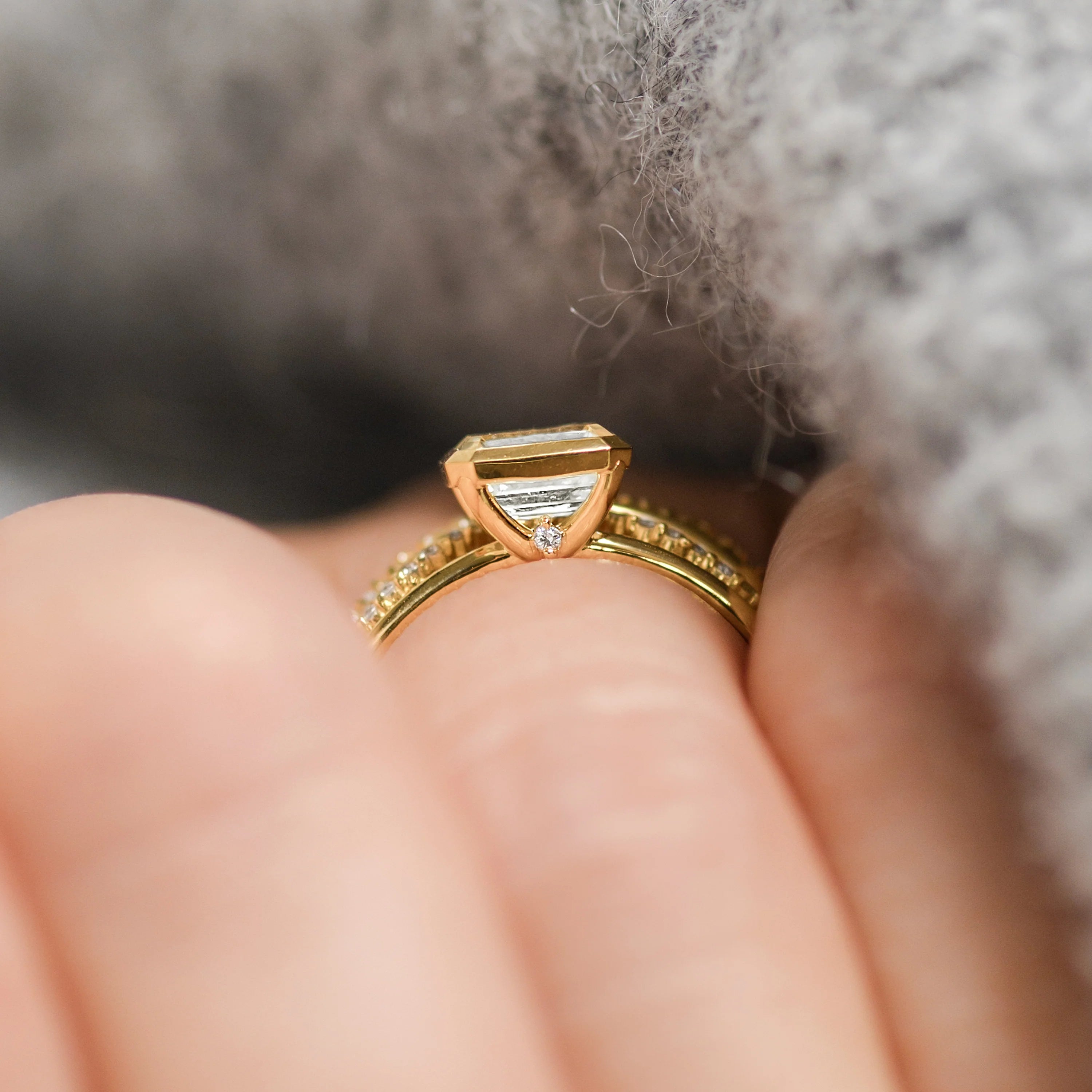 Elegant handmade emerald cut diamond engagement ring, featuring a bezel setting designed for women.