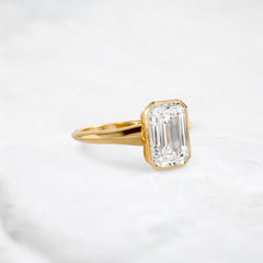 hidden-muse-emerald-glow-bezel-moissanite-engagement-ring-3-ct-yellow-gold-gemfora-2