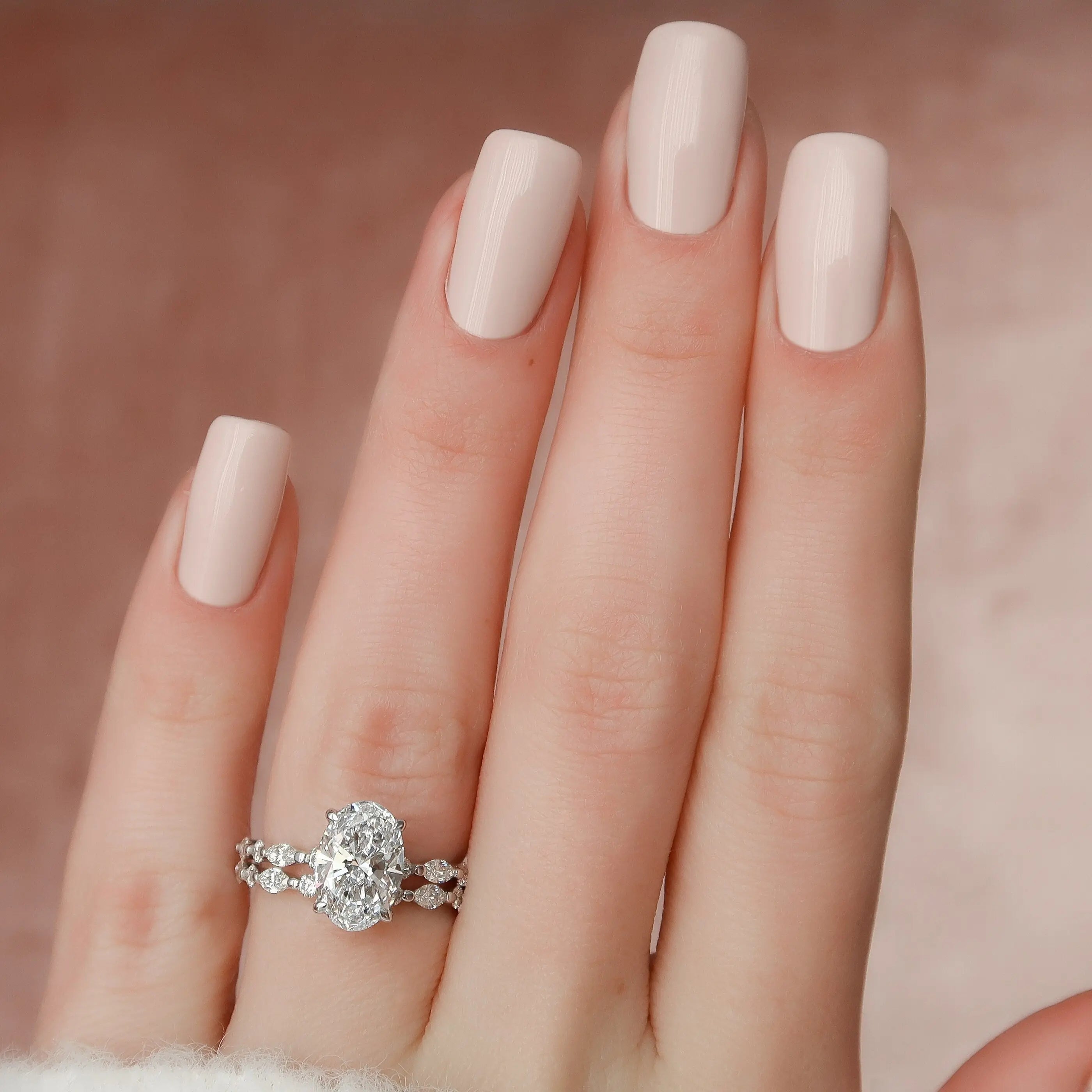 Oval cut moissanite engagement ring worn on hand