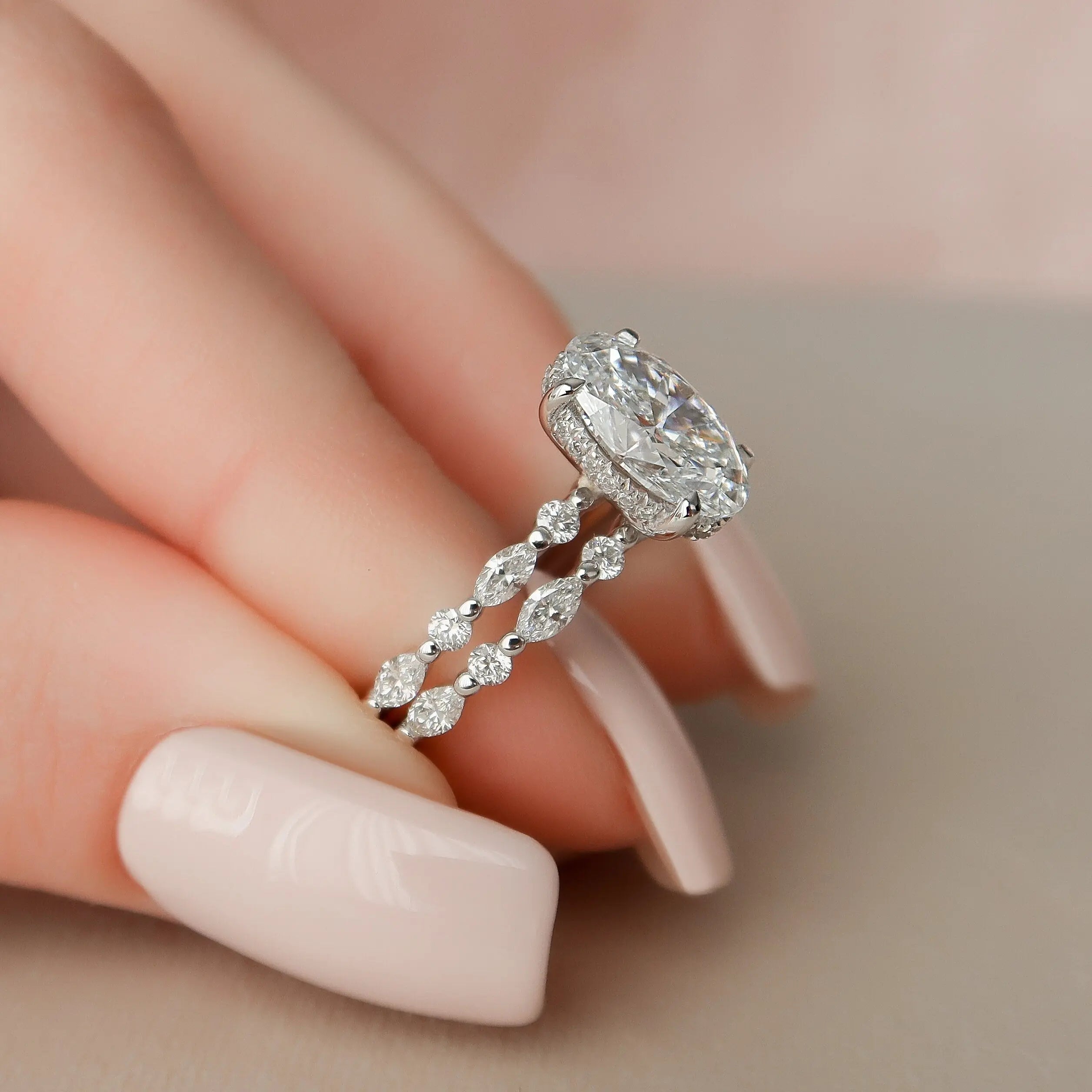 Oval moissanite halo ring with marquise side stones
