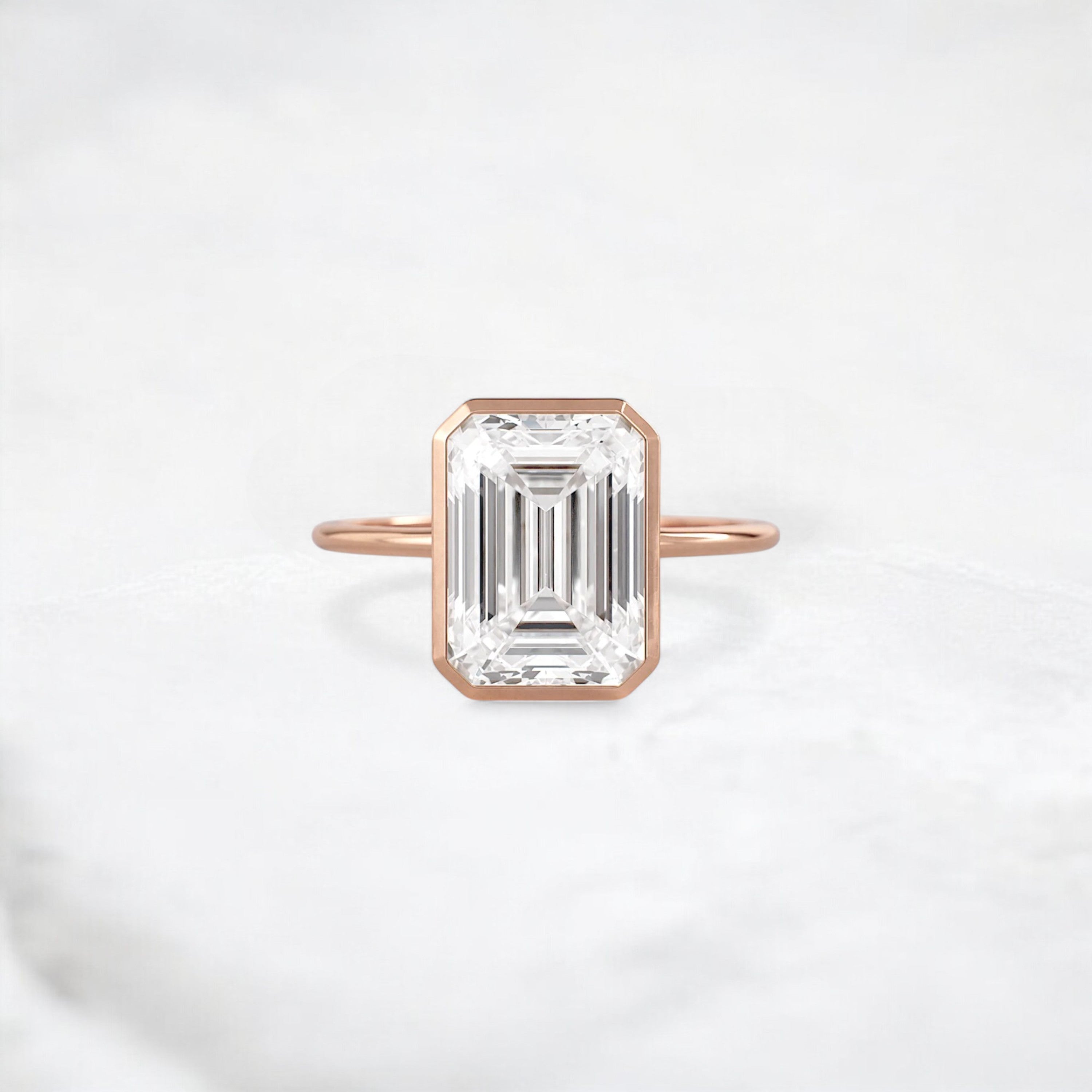 secret-glimmer-emerald-cut-bezel-moissanite-engagement-ring-4-ct-rose-gold-gemfora-1