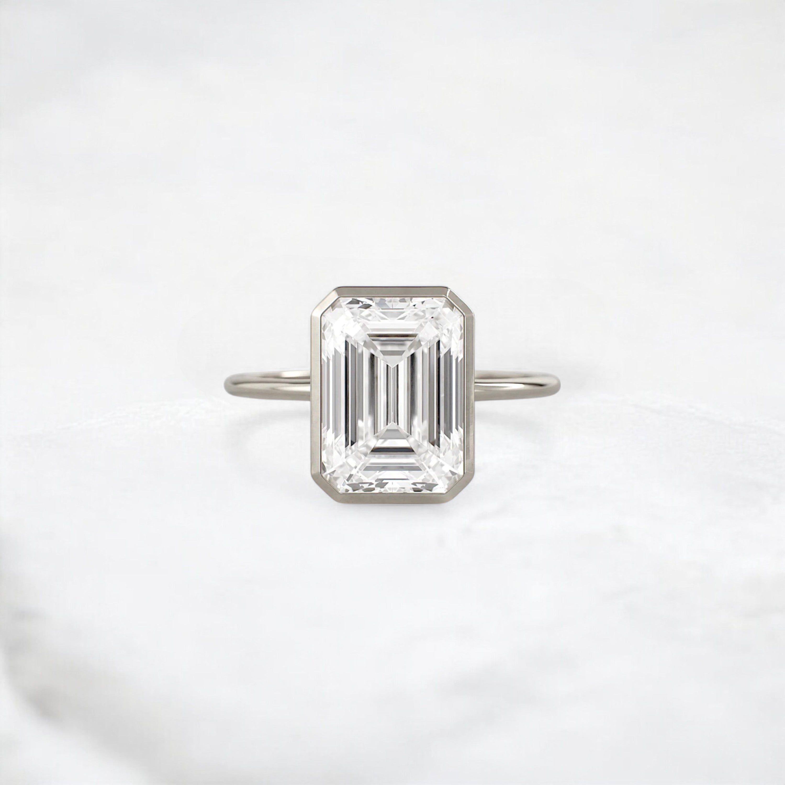 secret-glimmer-emerald-cut-bezel-moissanite-engagement-ring-4-ct-white-gold-gemfora-1