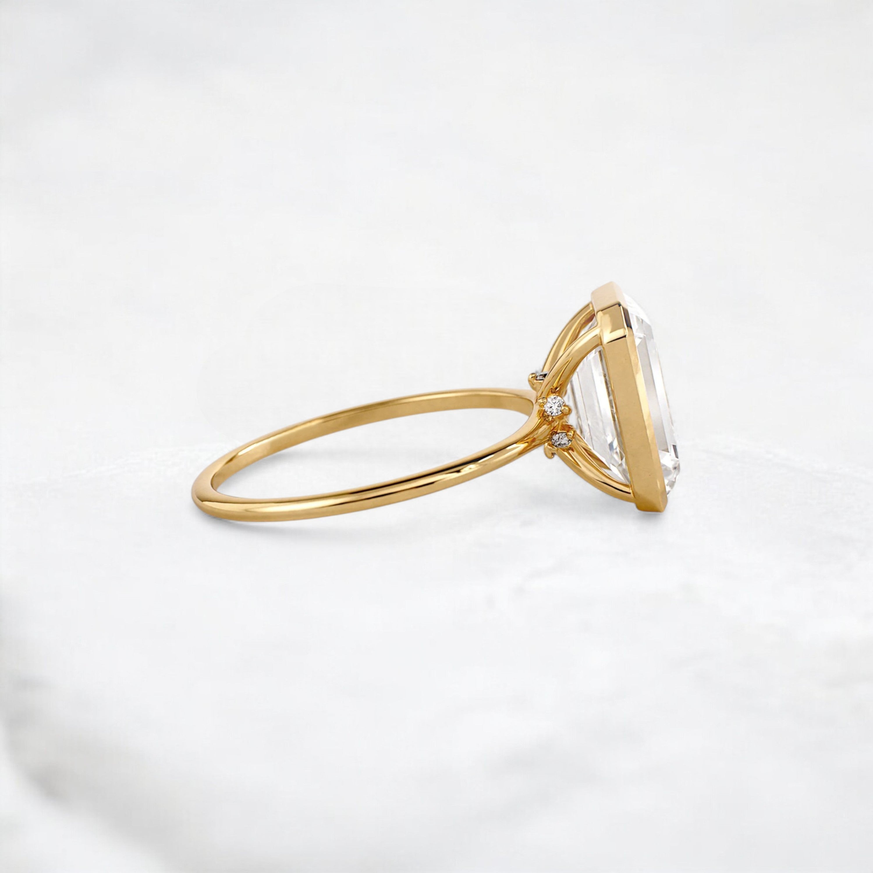 secret-glimmer-emerald-cut-bezel-moissanite-engagement-ring-4-ct-yellow-gold-gemfora-3